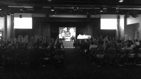 Jordan Johnson speaking to a full room